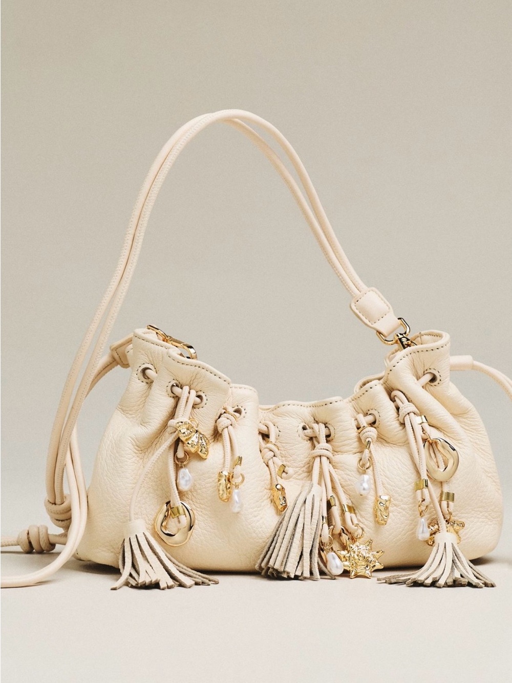 Dolce Vita Cream Tassel Drawstring Shoulder Bag with Gold Charms